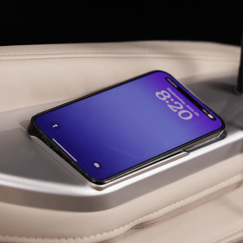 Kyota Joubu M880 4D massage chair armrest with built-in wireless charging pad for convenient phone charging.
