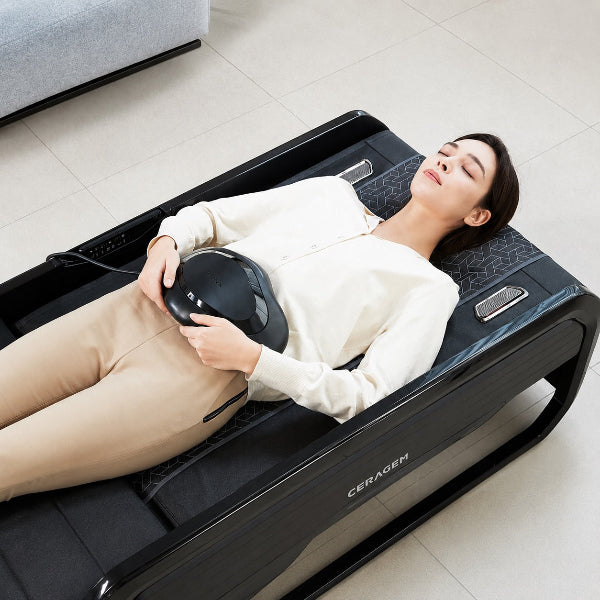 Heated abdominal massager attachment placed on the midsection, designed to deliver gentle massage and soothing warmth to the core area for enhanced relaxation.