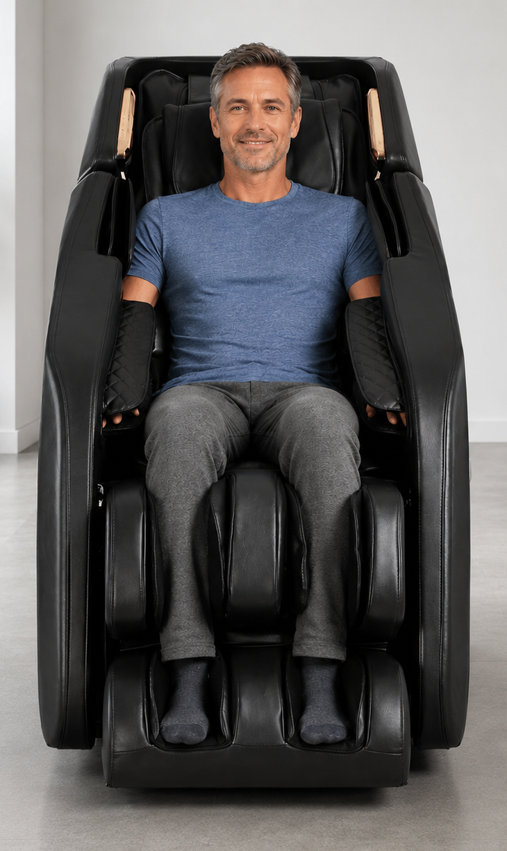 Middle-aged man relaxing in a black Daiwa massage chair in a modern room with light gray floors and white walls.