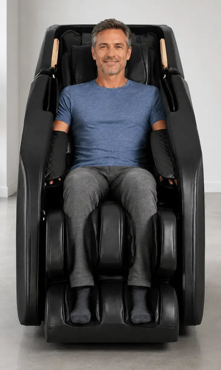 Middle-aged man relaxing in a black Daiwa massage chair in a modern room with light gray floors and white walls.