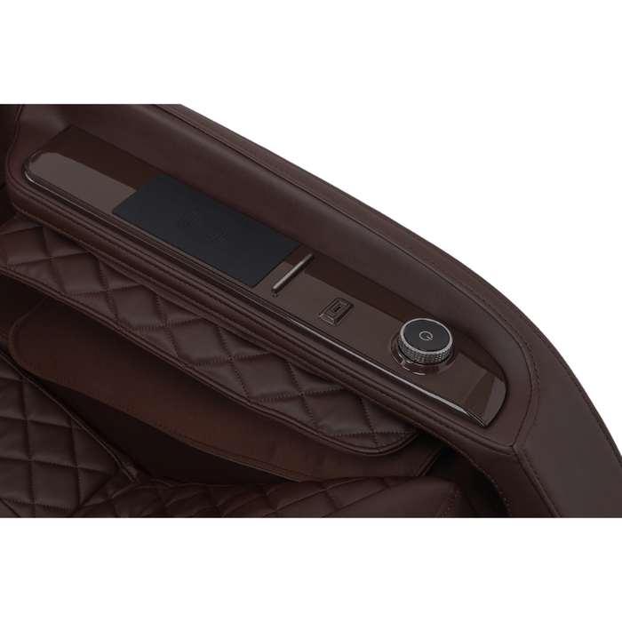 Close-up of the wireless charging pad on the brown Infinity Solstice Deluxe Massage Chair, integrated into the armrest for convenient device charging during use.