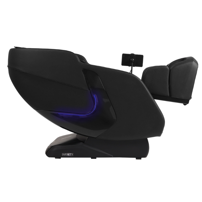 Side view of the black Infinity Solstice Deluxe massage chair in zero-gravity recline position, showing sleek armrest, extended footrest and L-track design.
