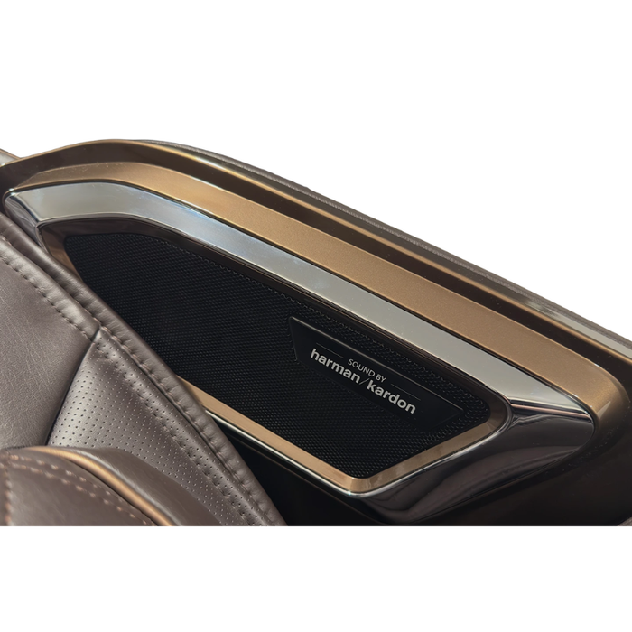 Close-up view of the Harman Kardon speaker integrated into the brown Infinity Ultra Imperial Syner-D massage chair showcasing premium audio and luxury design details.