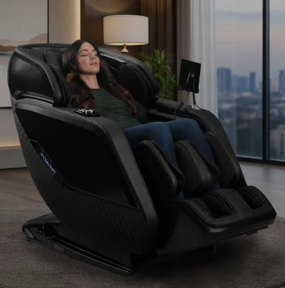 Infinity Sovana 4D DualPro Massage Chair in sleek black finish, placed in a modern living room setting with stylish décor and natural lighting.