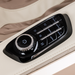 Close-up of beige Infinity Sovana 4D DualPro massage chair control panel and luxurious upholstery.