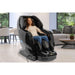 Person using black Kyota Yosei M868 4D massage chair in a living room.