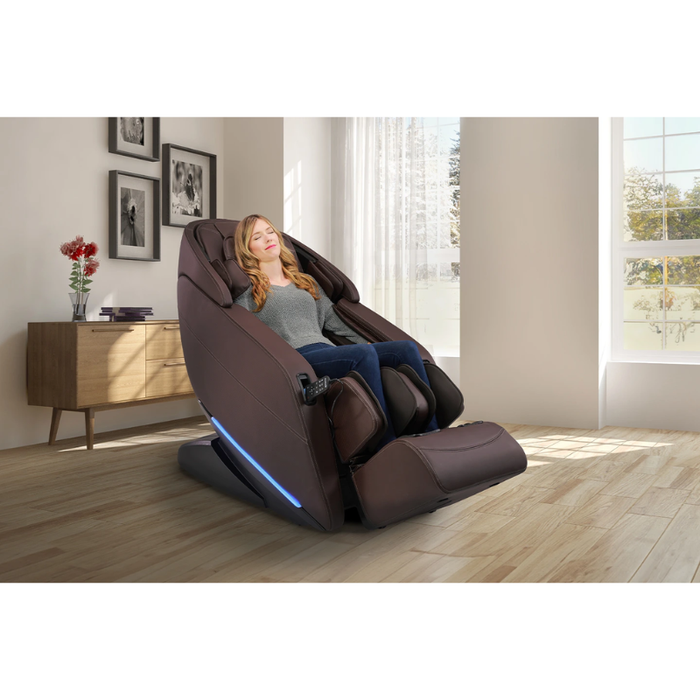 Kyota Yugana M780 4D Massage Chair in rich brown leather-look, front view placed in a living room setting with extended leg rest and ambient décor.