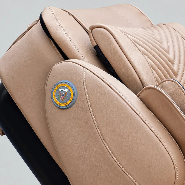 Close-up of the Luraco iRobotics i11 Special Edition Medical Massage Chair in cream leather, featuring the Made in America emblem and premium stitched upholstery.