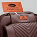 Close-up of the Luraco iRobotics 11 Special Edition Medical Massage Chair in chocolate brown leather, featuring a personalized engraved Luraco badge honoring Dr. William A. Jackson.