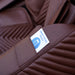 Close-up of the Luraco iRobotics 11 Special Edition Medical Massage Chair in chocolate brown leather, featuring a built-in smartphone holder for convenient access during massage sessions.