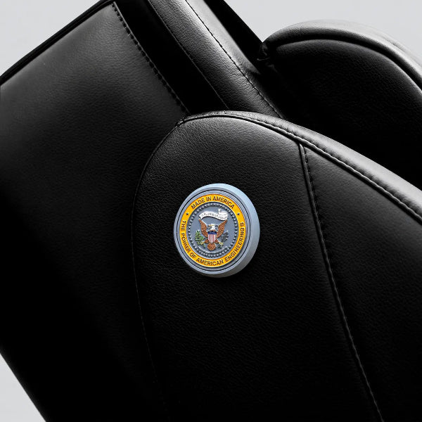 Close-up of the Luraco iRobotics i11 Special Edition Medical Massage Chair in black leather, featuring the Made in America emblem and premium stitched upholstery.