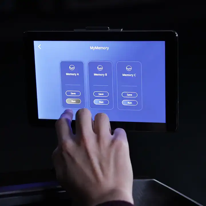 Touchscreen display showing custom MyMassage program options and saved presets.