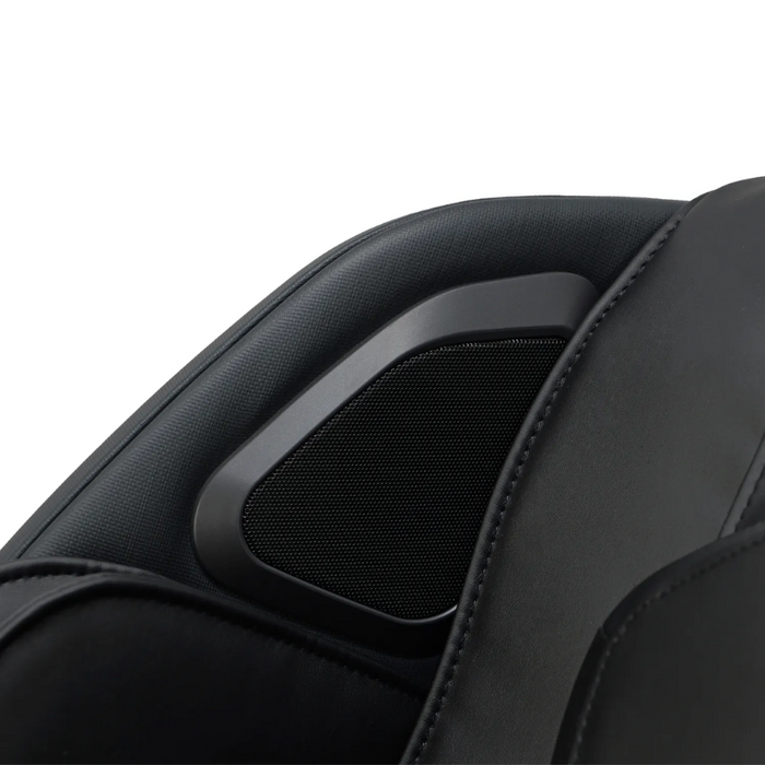Close-up of built-in Bluetooth speakers on the Osaki 4D YogaFlex chair, showing speaker grilles integrated into the headrest/armrest area against plush upholstery.