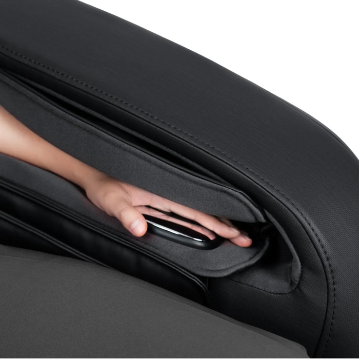 Hand pressing the intelligent health sensor pad on the Osaki 4D YogaFlex massage chair, with the sensor area built into the armrest and framed by black upholstery.