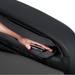 Hand pressing the intelligent health sensor pad on the Osaki 4D YogaFlex massage chair, with the sensor area built into the armrest and framed by black upholstery.