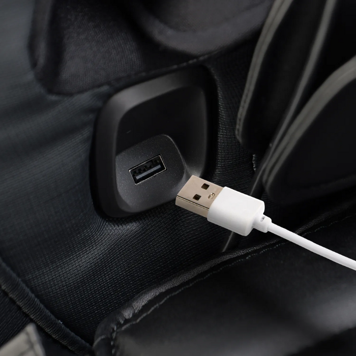 Close-up of the Osaki 4D YogaFlex massage chair’s USB port built into the armrest, with a cable plugged in and sleek upholstery surrounding the charging interface.