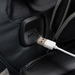 Close-up of the Osaki 4D YogaFlex massage chair’s USB port built into the armrest, with a cable plugged in and sleek upholstery surrounding the charging interface.