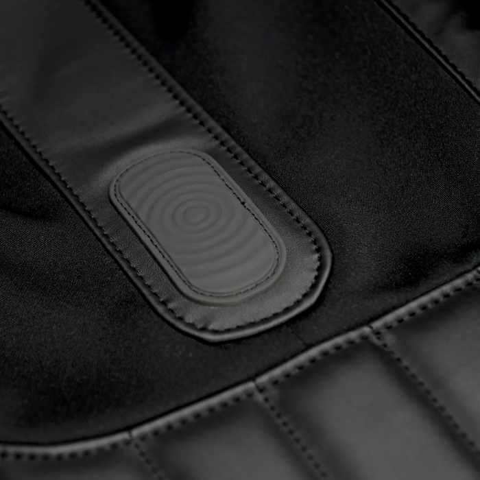 Close-up of the YogaFlex massage chair’s seat section vibrating, with subtle wave-pattern upholstery wrinkles indicating motion.