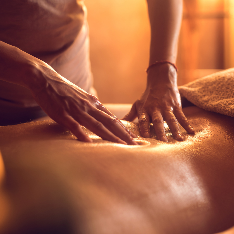 Massage chair performing shiatsu massage with rotating rollers applying deep, targeted pressure to key acupressure points on the back.