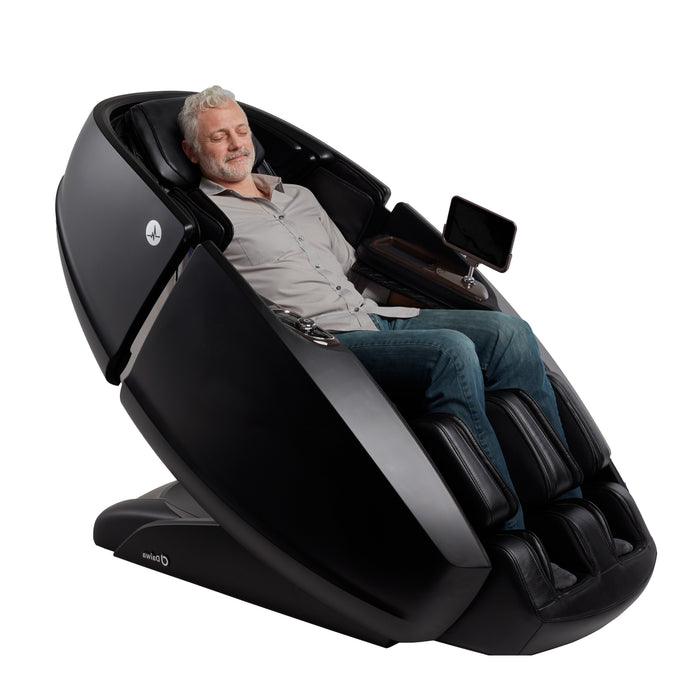 A person relaxing in a black Daiwa Supreme Hybrid X at a slight angle, showcasing the premium Saffiano leather exterior and the intuitive armrest control position.