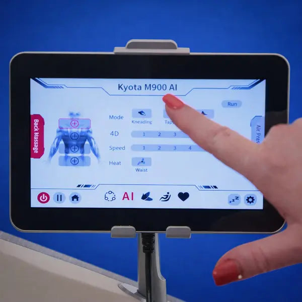 User activating AI body scan on Kyota Hatsumei M900 touchscreen controller for personalized 4D massage adjustment.