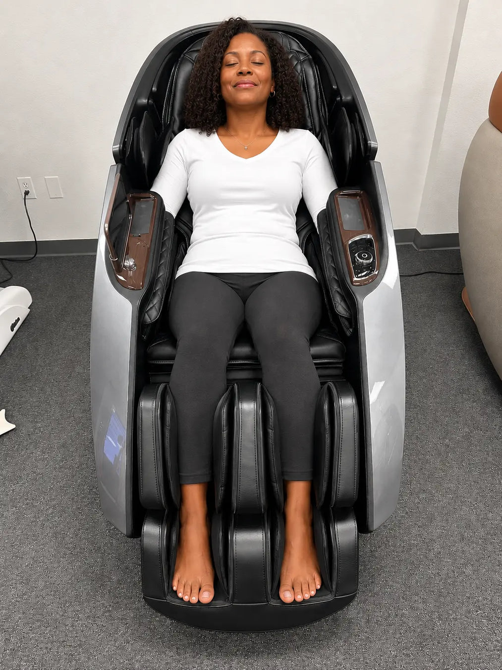 Woman relaxing in the grey Daiwa Supreme Hybrid X massage chair at The Modern Back Denver, CO showroom.