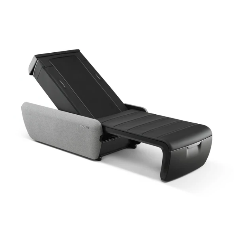 Angled view of CERAGEM V9 massage bed in black showing sleek therapeutic design and adjustable reclining position.