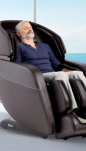 Person relaxing in Daiwa Legacy 4 massage chair using automatic massage programs.