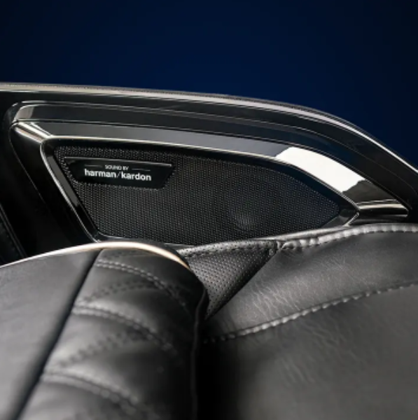 Close-up image of the Harman/Kardon® Premium Audio speakers integrated into the Infinity Ultra Imperial Syner-D massage chair showcasing immersive luxury sound technology.