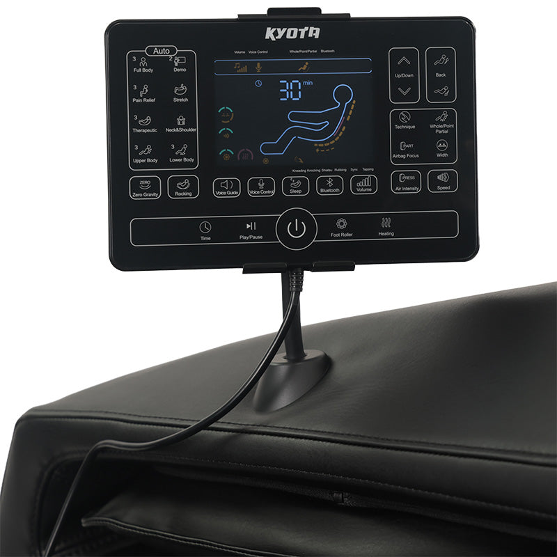 Close-up of the Kyota Zenyu M338 massage chair’s tablet-style controller displaying massage menu options.
